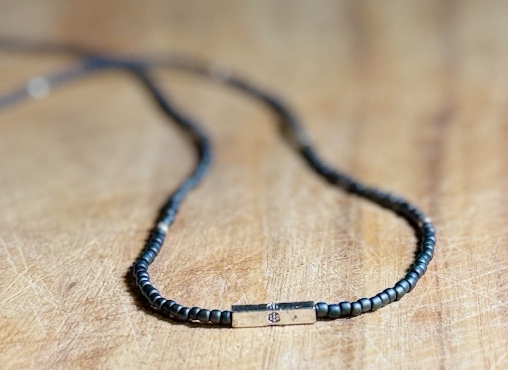 Steel Grey Stretchy Seed Bead Necklace with Silver Squared Floral Stamped Charm