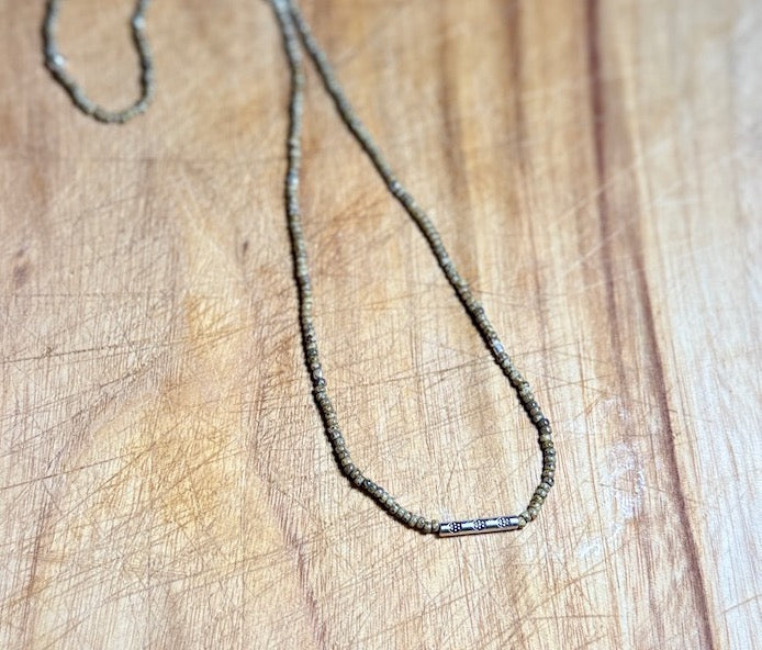 Speckled Beige Stretchy Seed Bead Necklace with Rounded Silver Floral Stamped Charm