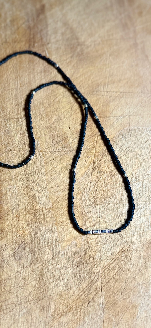 Black Stretchy Seed Bead Necklace with Rounded Silver Floral Stamped Charm
