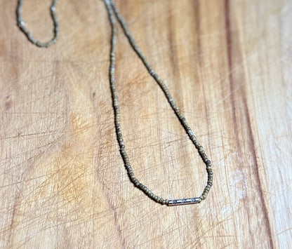 Speckled Beige Stretchy Seed Bead Necklace with Rounded Silver Floral Stamped Charm