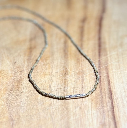 Speckled Beige Stretchy Seed Bead Necklace with Rounded Silver Floral Stamped Charm