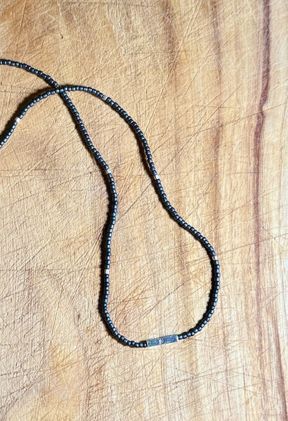 Steel Grey Stretchy Seed Bead Necklace with Silver Squared Floral Stamped Charm