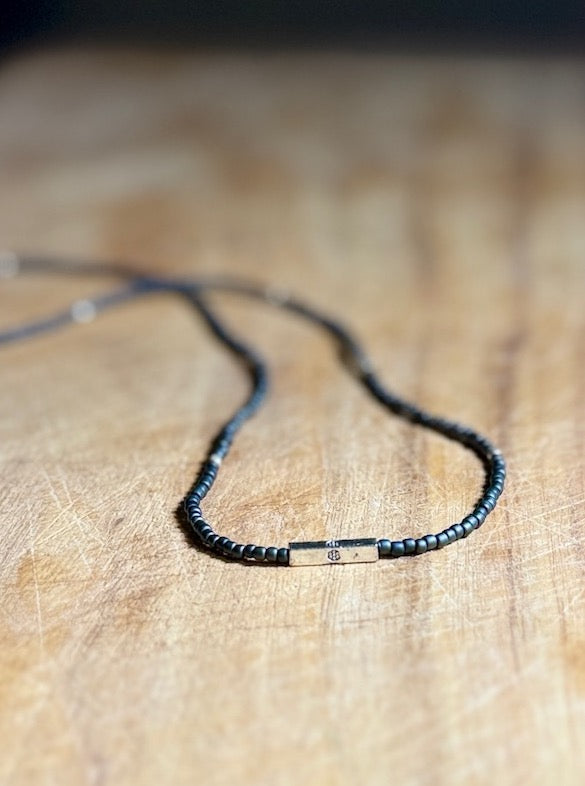 Steel Grey Stretchy Seed Bead Necklace with Silver Squared Floral Stamped Charm