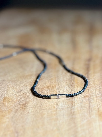 Steel Grey Stretchy Seed Bead Necklace with Silver Squared Floral Stamped Charm