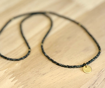 Speckled Black Stretchy Seed Bead Necklace with Brushed Gold Circle Charm