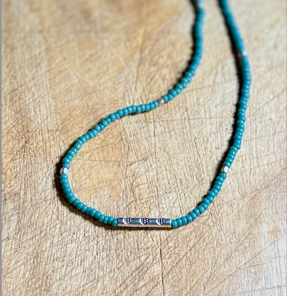 Eucalyptus Green Stretchy Seed Bead Necklace with Rounded Silver Floral Stamped Charm